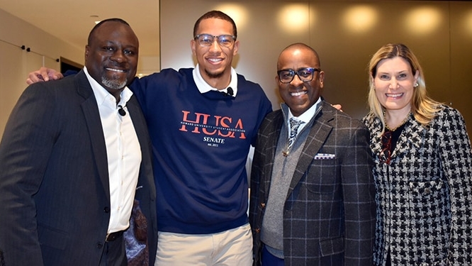 Four smiling professionals, including Marcus Shaw, stand together at an Apollo event, representing collaboration and opportunity in the alternative investments industry.