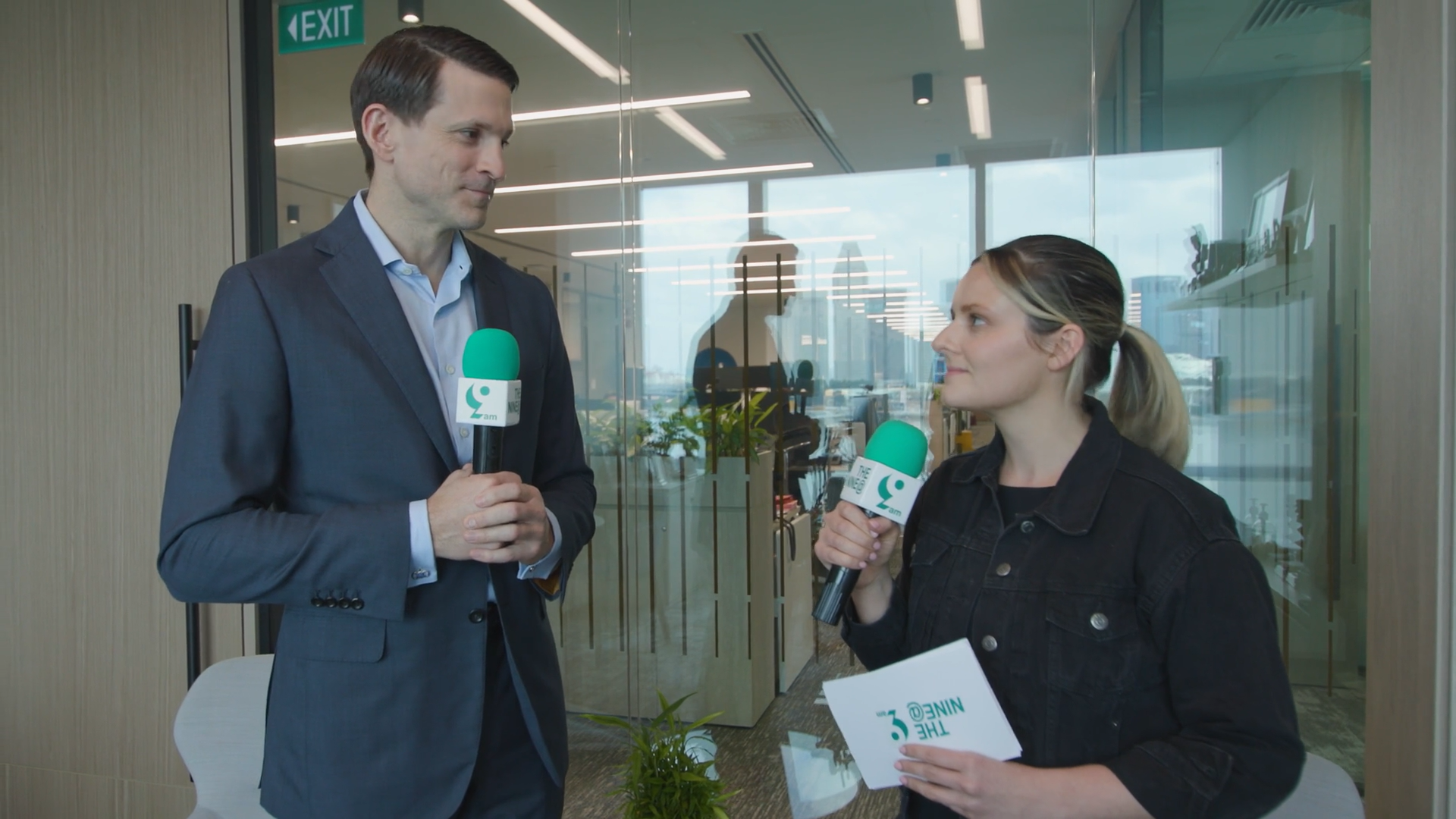 Poster for Apollo’s 9@9 episode featuring Matt Michelini, Head of Asia Pacific standing in the office holding a green microphone, highlighting his leadership role and presence in Singapore