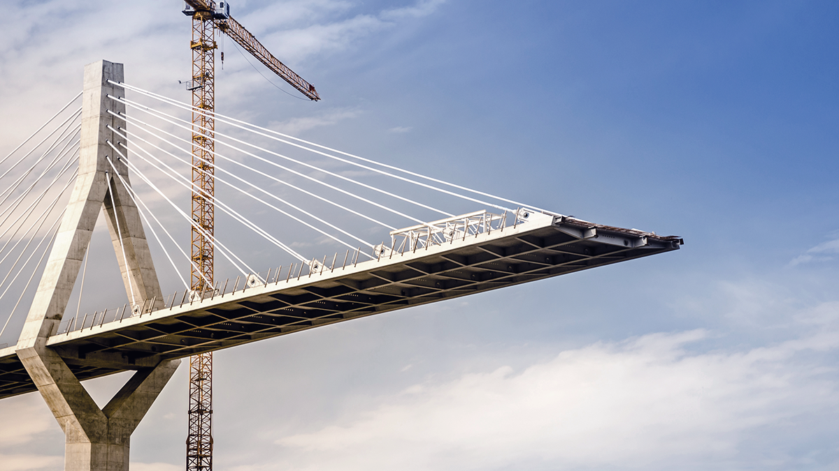 Partially constructed cable‑stay bridge with cranes, symbolizing tailored and robust financing—representing Apollo’s flexible credit solutions crafted to support ambitious growth and infrastructure realization.