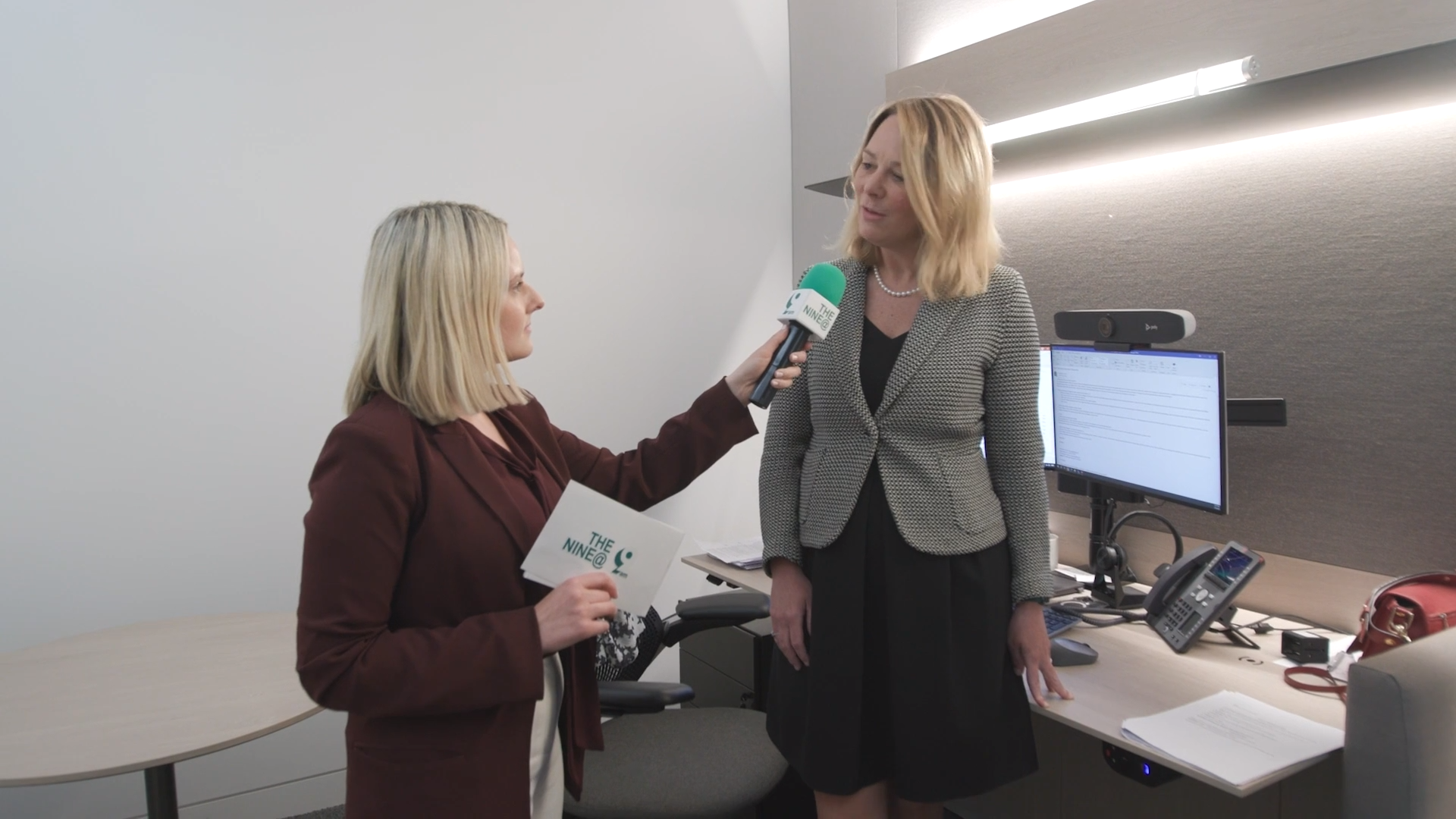A woman interviews Veronique Fournier, Head of EMEA Wealth Distribution, in her office, highlighting insights into wealth management and alternative investment strategies.